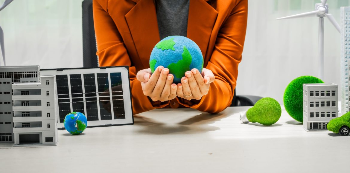 A businesswoman working at a desk in sustainable urban development, promoting eco-friendly