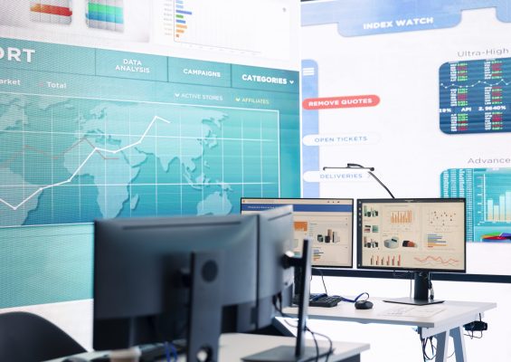 Multinational company headquarters office with a big data screen, technology used for employees to monitor numbers and infographics relevant to business development or expansion.