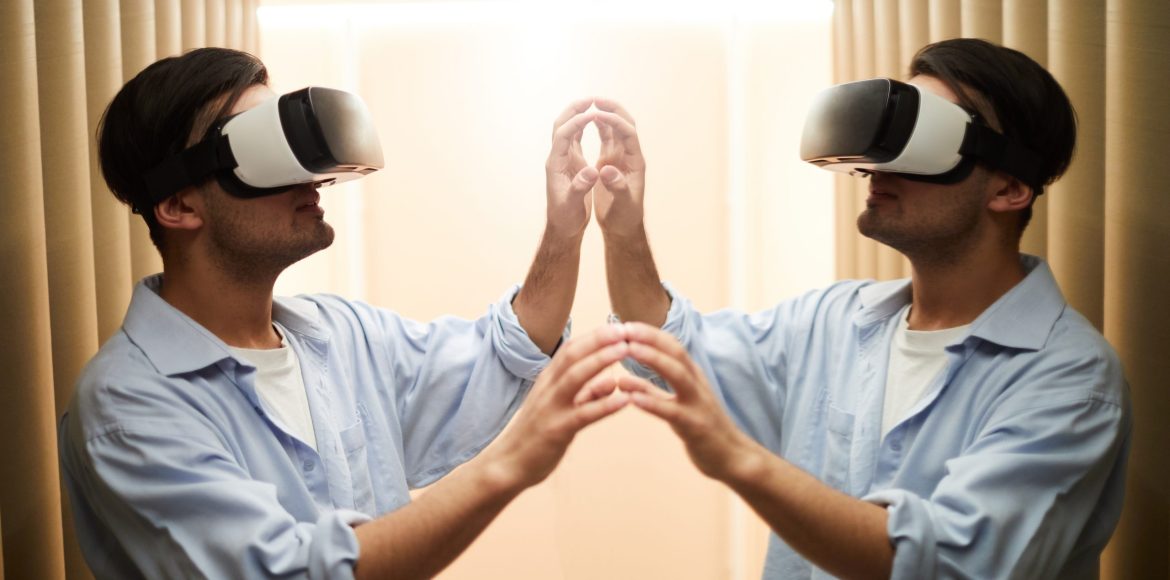Young man with vr goggle touching mirror and his reflection during virtual experience in another reality